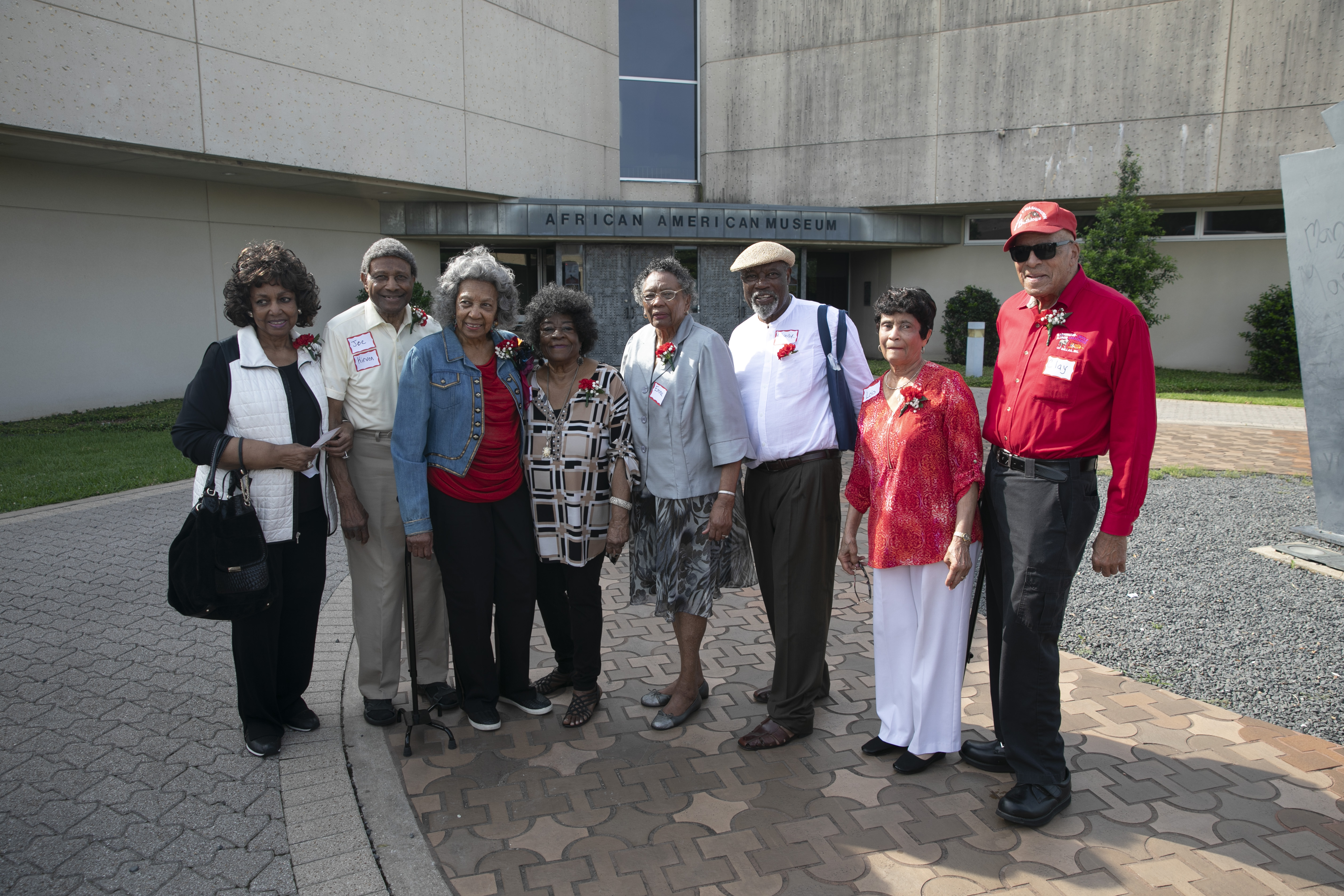 Eight Booker T. Washington High School graduates of the class of 1949 lined up to pose for a picture in front of Dallas’ African American Museum June 3, 2019. Photo by Lupe Hernandez Jr.