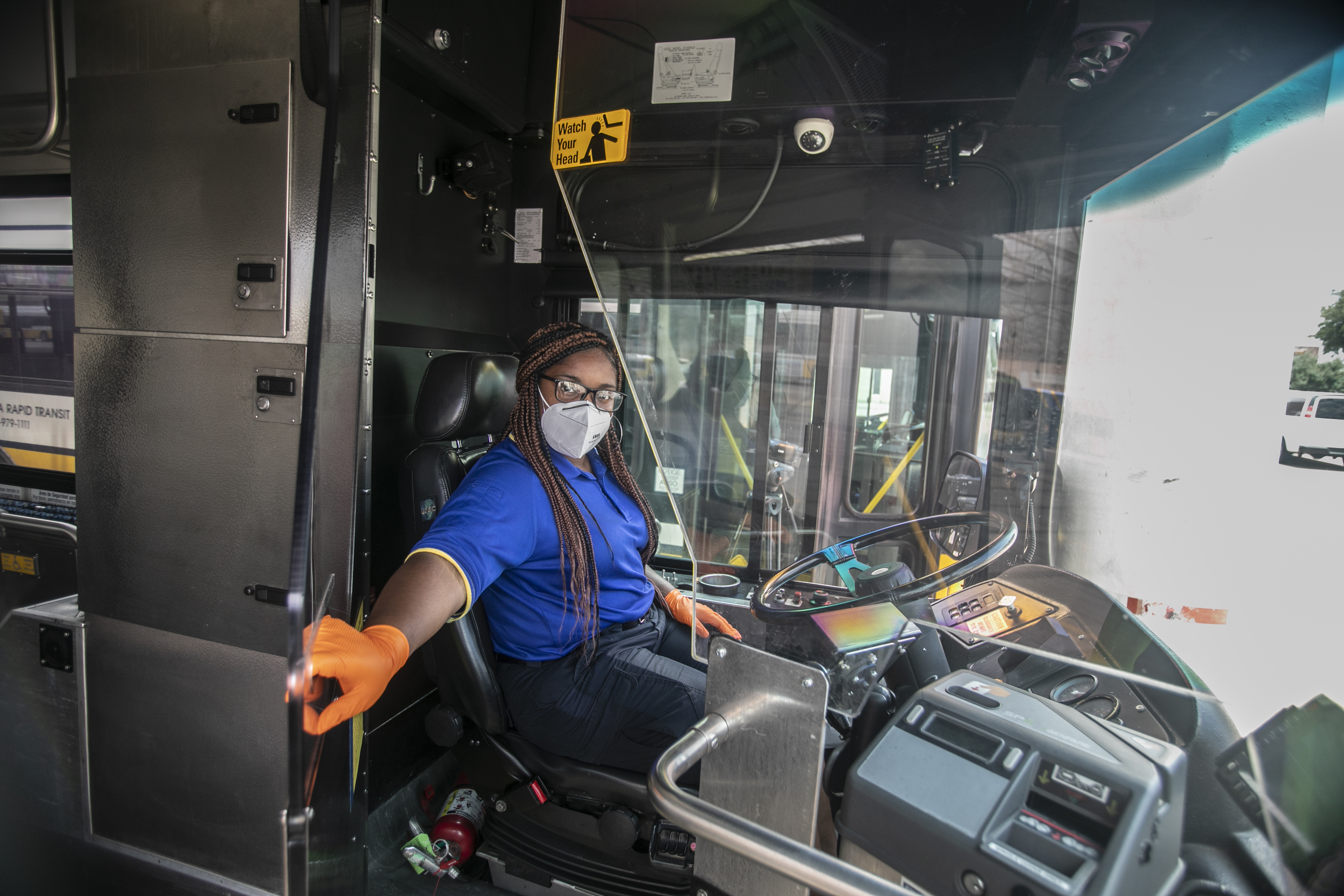 DART bus operator holds respiratory droplet shield. These shields are made of high-impact plexiglass and help protect operators and passengers during the COVID-19 pandemic.
