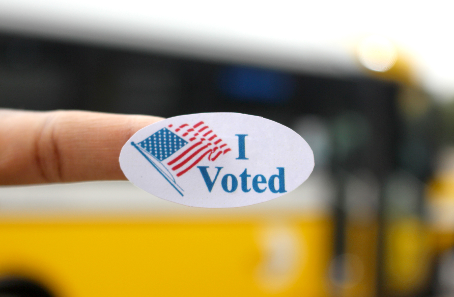 An "I voted" sticker near a DART bus at Belt Line Station in Irving.